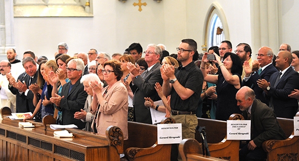 The family of Father Gerard Skrzynski express their joy as Bishop Richard J. Malone announces Father Skrzynski's assignment to the St. Vincent de Paul Church in Niagara Falls during the Ordination Mass at St. Joseph Cathedral. 